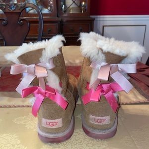Size 4 brown Ugg boots with pink ribbons.